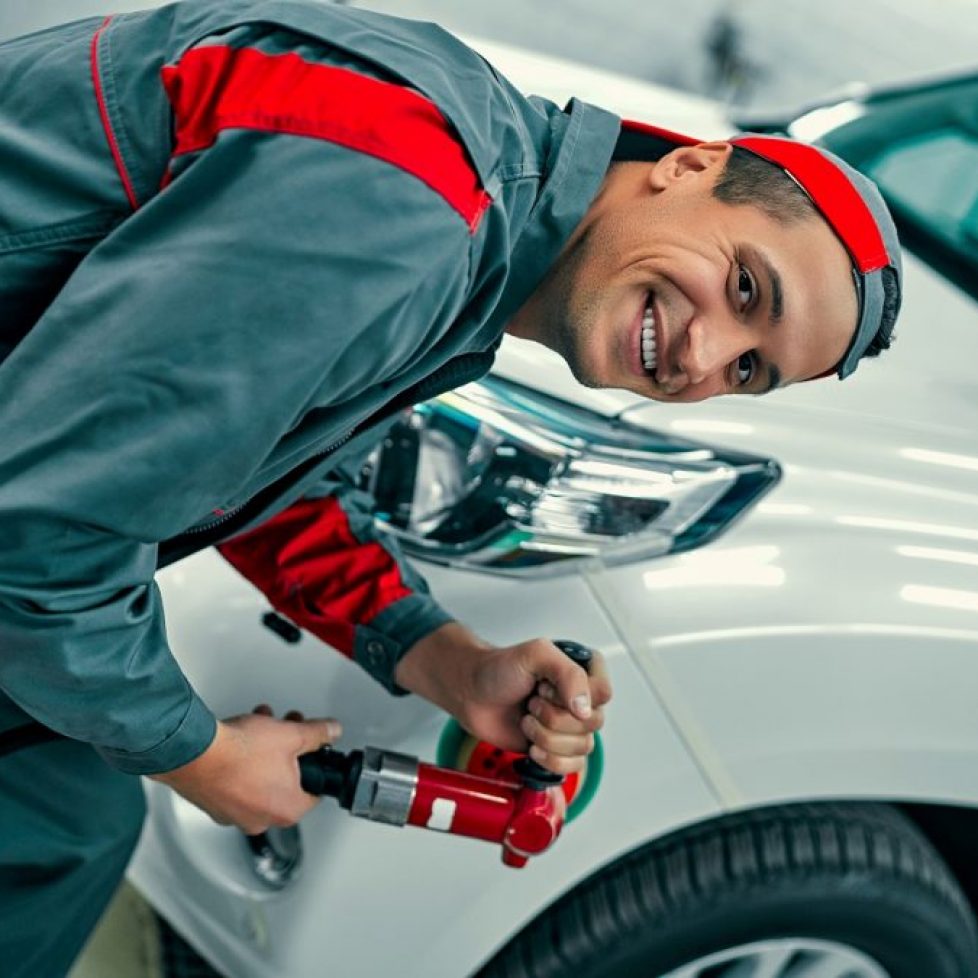 mechanic buffing a car's body